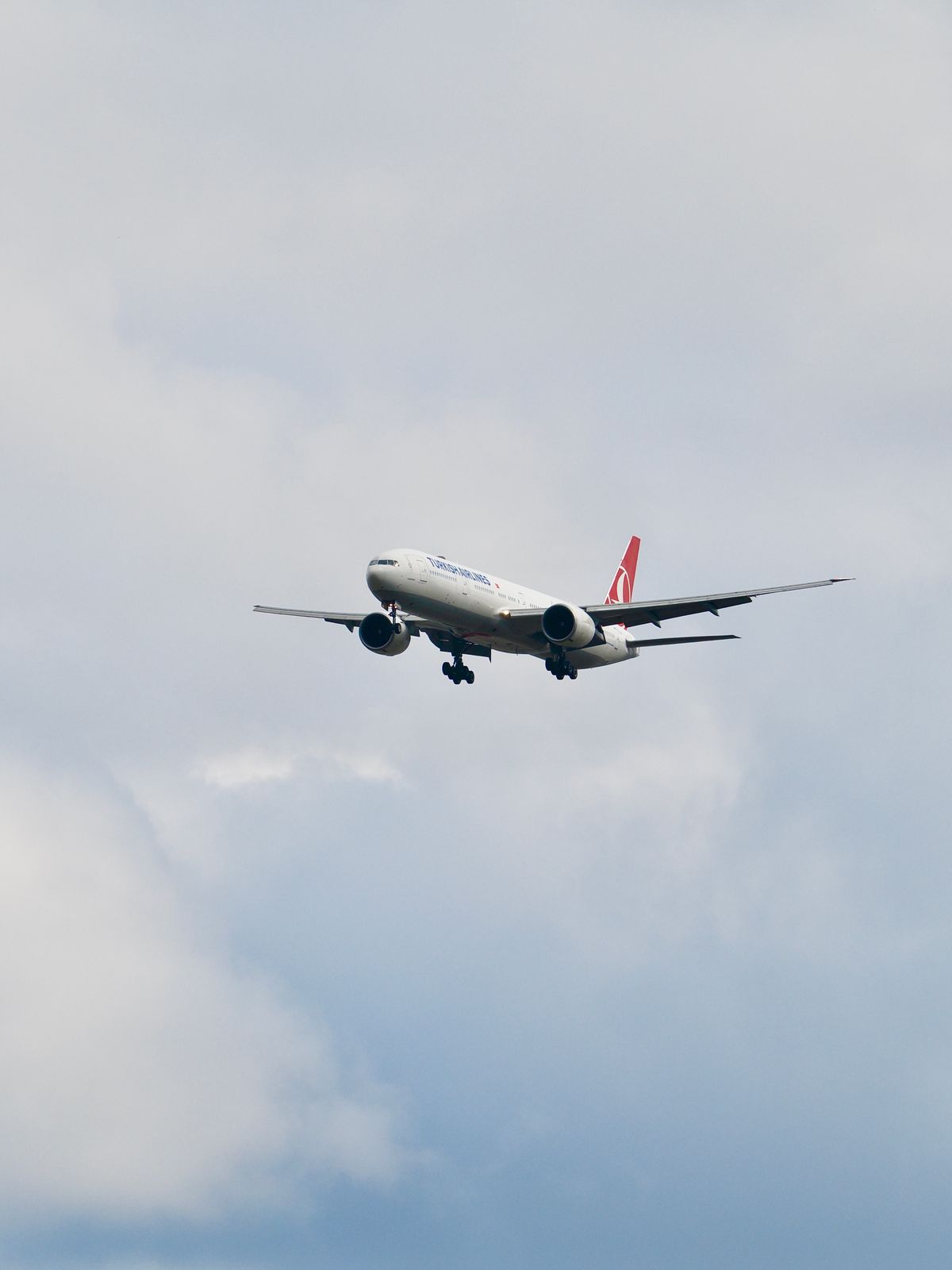 Commercial airplane flying in a clear blue sky