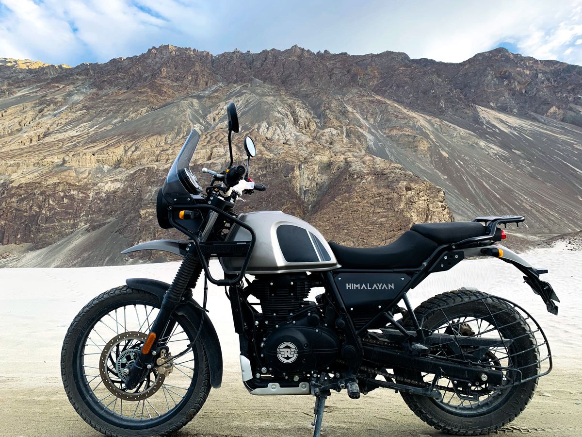 Royal Enfield Himalayan motorcycle parked against a scenic mountain backdrop on the Manali to Spiti route