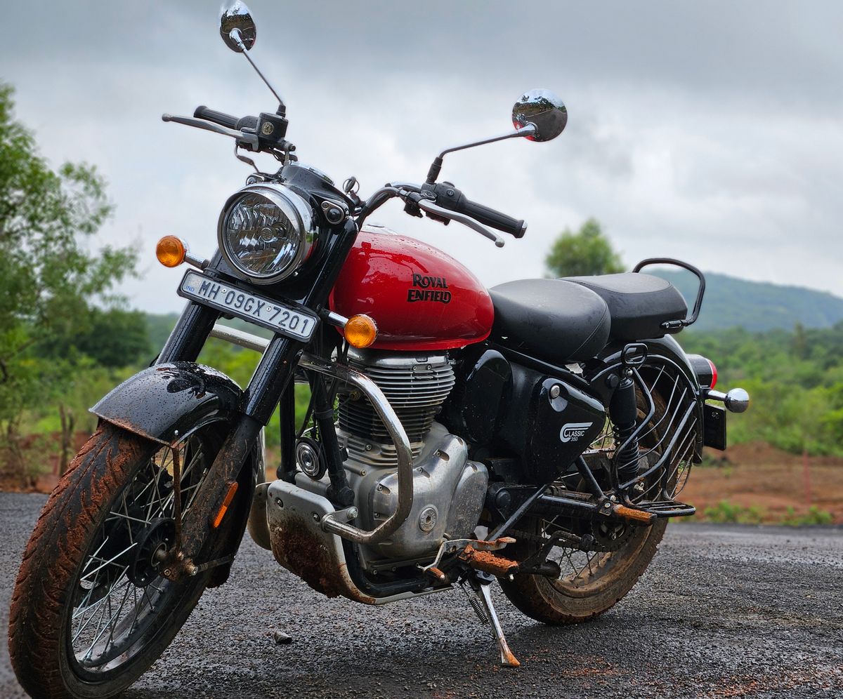 Classic Royal Enfield motorcycle parked on a scenic outdoor road, available for self-drive rental